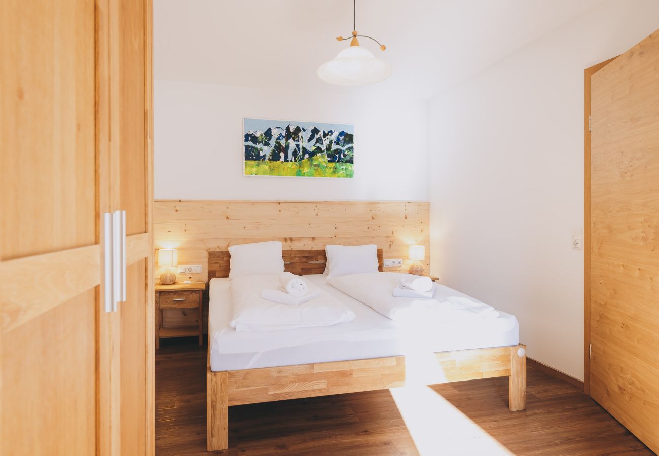 Bedroom in the holiday apartment Haus Altenberger Apartments by we rent. Cozy double bed with bedding.